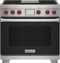 Wolf 36&quot; 4 Burner Dual Fuel Range with Infrared Griddle (DF36450G/BK/P) featuring black accent colored door and signature red Wolf knobs.