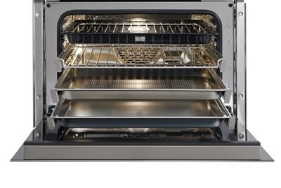 Interior view of an open Wolf 24&quot; E Series Transitional Convection Steam Oven with its four oven racks extended