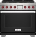 Wolf 36" 6 Burner Dual Fuel Range (DF36650/BK/P) featuring black accent colored door and signature red Wolf knobs.