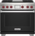 Wolf 36" 4 Burner Dual Fuel Range with Infrared Griddle (DF36450G/BK/P) featuring black accent colored door and signature red Wolf knobs.