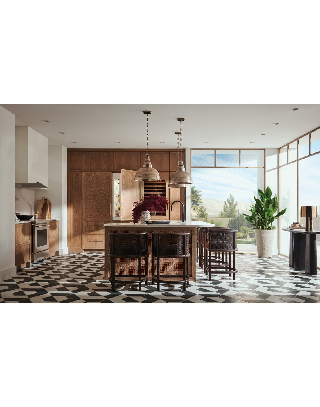 Panel Ready Sub-Zero 30 Inch Freezer Column with Ice Maker paired with Sub-Zero 30 Inch Tall Refrigerator with Internal Dispenser shown in a modern bright and open custom kitchen design