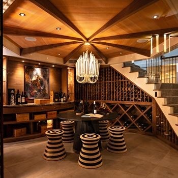A cavern-like wine cellar for storage and celebration is the centerpiece of a New England home.