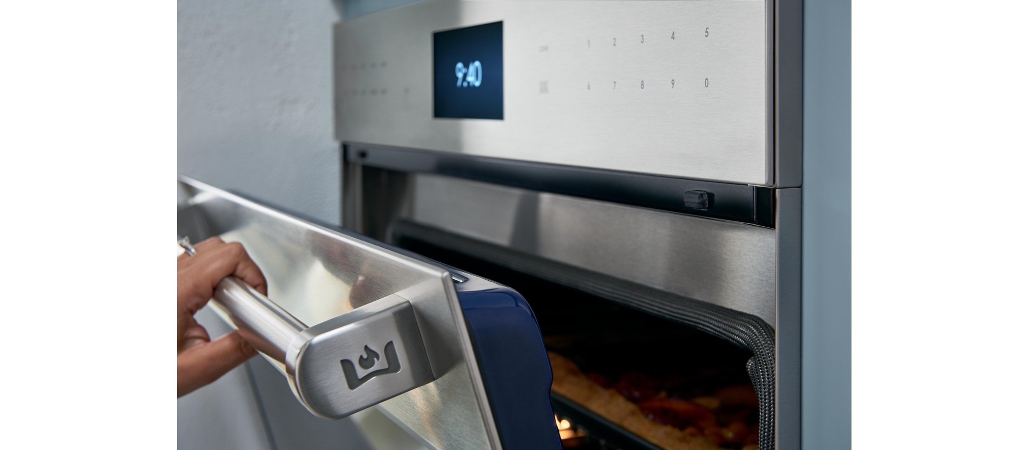 Chef product demonstration with Wolf Dual Stacked Burners at Sub-Zero, Wolf and Cove Showroom in Auburn Hills, Michigan