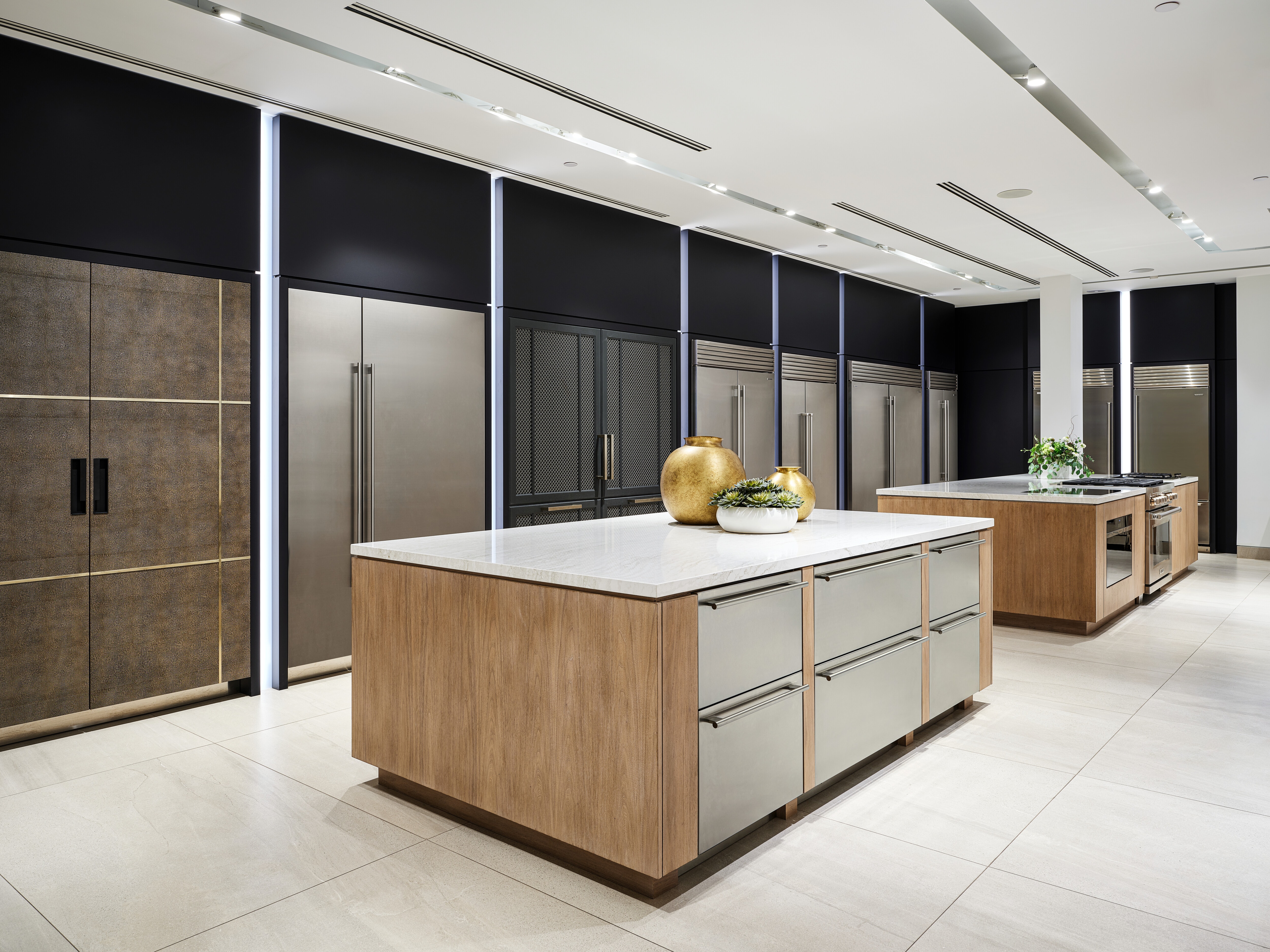 A wall of built-in Sub-Zero refrigerators in different shapes, configurations, and sizes. 