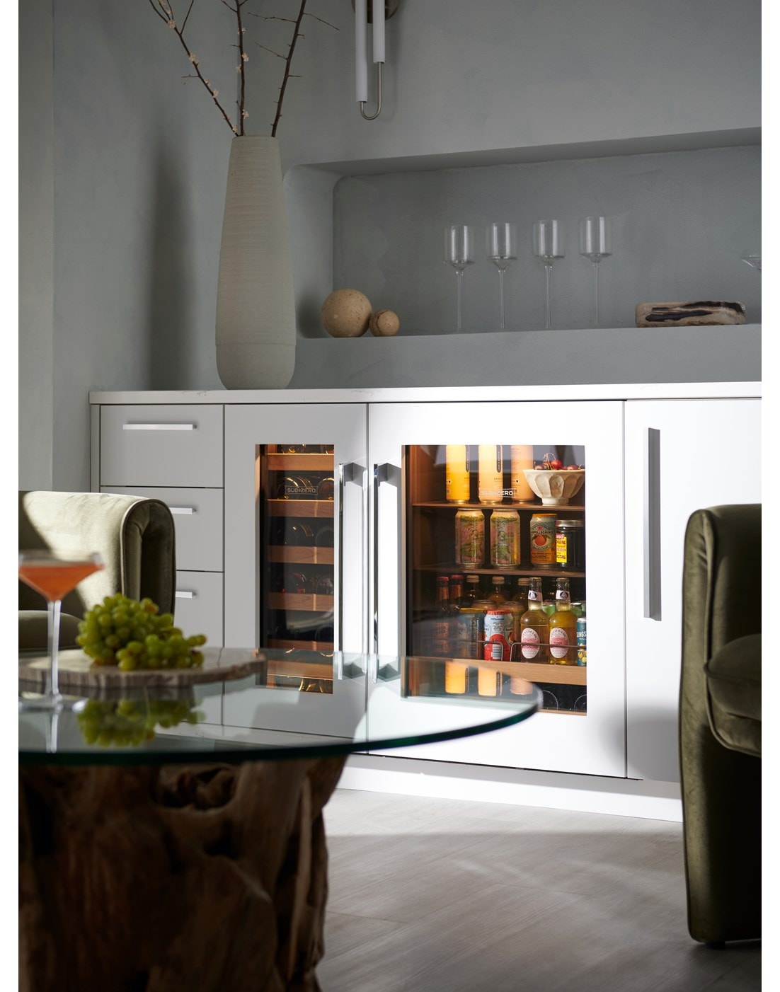 Panel Ready Sub-Zero 15 inch Designer Undercounter Wine Storage paired with a Wi-Fi ready Sub-Zero Designer Undercounter Beverage Center set in a custom sleek minimal European designed space