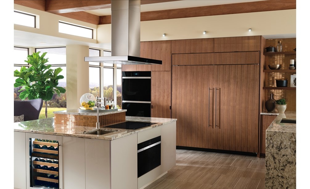 Wolf 30" Contemporary Induction Cooktop (CI304C/B) featured in large marble kitchen island with Wolf 42" Cooktop Island Hood (VI42B)