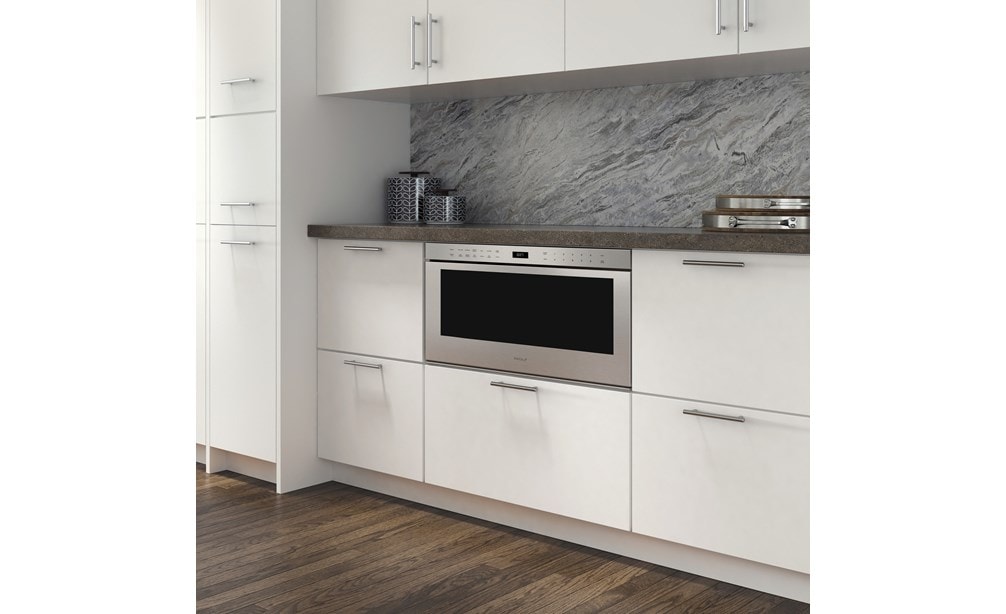 The Wolf 30" Professional Drawer Microwave Oven (MD30PE/S) shown adding ease and convenience set in classic white cabinetry 