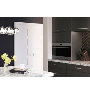 Wolf 30" E Series Transitional Drop-Down Door Microwave Oven (MDD30TE/S/TH) set expertly in smooth cabinetry against gray backsplash