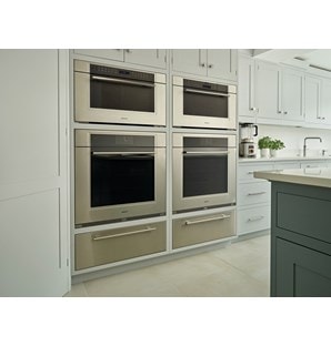 Wolf 30" M Series Transitional Convection Steam Oven (CSO30TM/S/TH) in custom dark wood pantry delivers visual and edible elegance