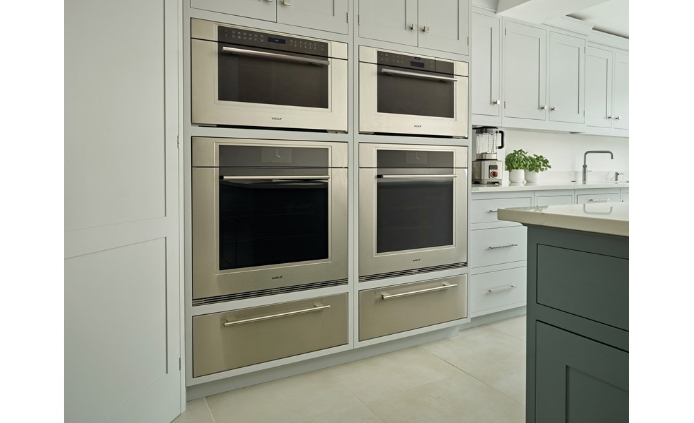 Wolf 30" M Series Transitional Convection Steam Oven (CSO30TM/S/TH) in custom dark wood pantry delivers visual and edible elegance