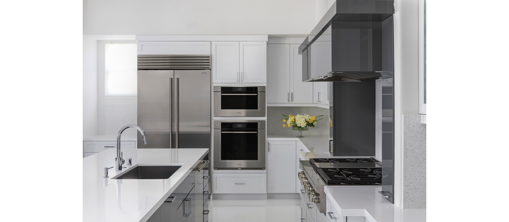 Wolf 30" M Series Transitional Convection Steam Oven (CSO3050TM/S/T) shown in a dimly lit kitchen with glossy white floors and countertops