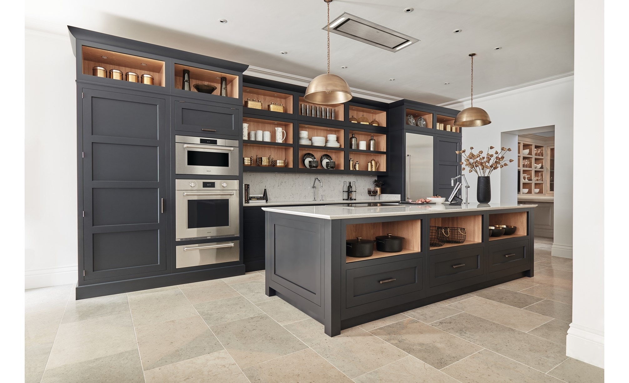 Wolf 30" M Series Professional Convection Steam Oven (CSO3050PM/S/P) immersed in tall matte gray custom cabinetry in stoned tiled kitchen