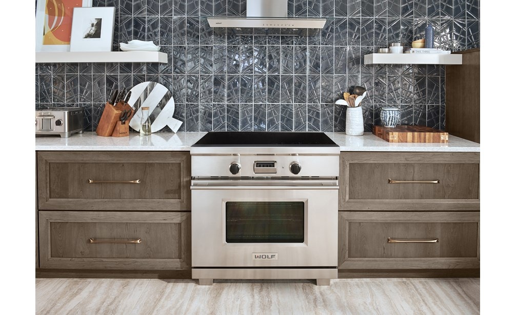 The Wolf 36" Transitional Induction Range (IR365TE/S/TH) featured with Wolf 36" Cooktop Wall Hood - Glass (VW36G)