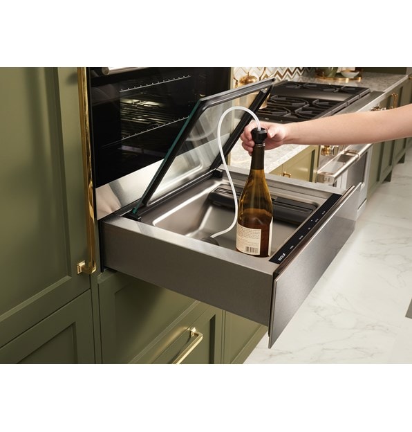 The Wolf 24" Vacuum Seal Drawer (VS24) shown protecting and prolonging the life of uncorked wine using the attachment provided 