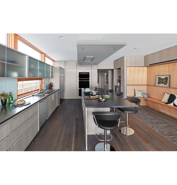 Wolf 36" Ceiling Mounted Hood Stainless Steel (VC36S) shown blending seamlessly above large kitchen island in modern minimalist kitchen