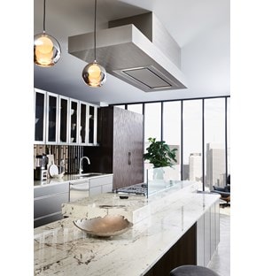The 48" Ceiling Mounted Hood - Stainless Steel (VC48S) shown adding polish and luxury above large rich swirl granite kitchen countertop
