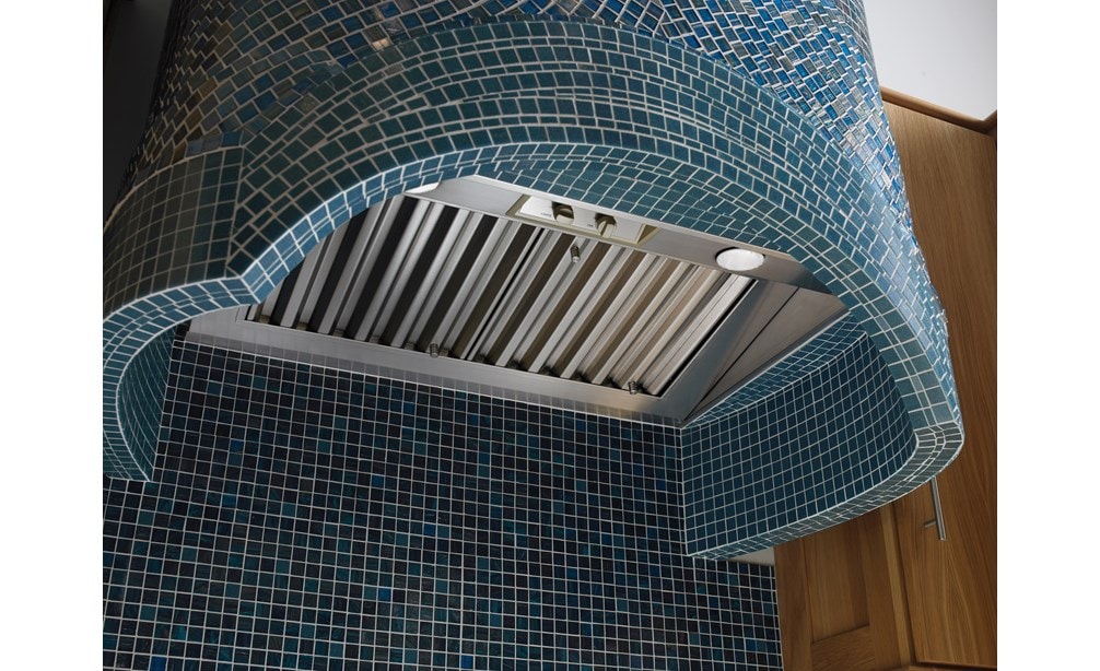 The Wolf 34" Pro Hood Liner 22" Depth (PL342212) shown expertly complimenting an artistic mosaic tiled kitchen range hood
