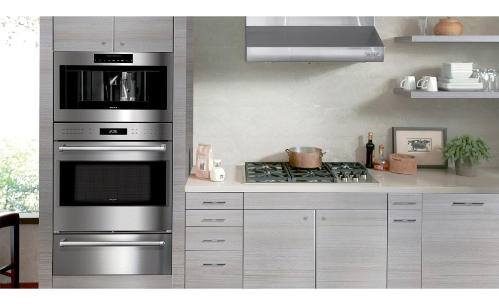 Wolf 30" Low Profile Wall Hood (PW302210) shown in clean, compact and powerful kitchen design featuring best-in-quality Wolf appliances