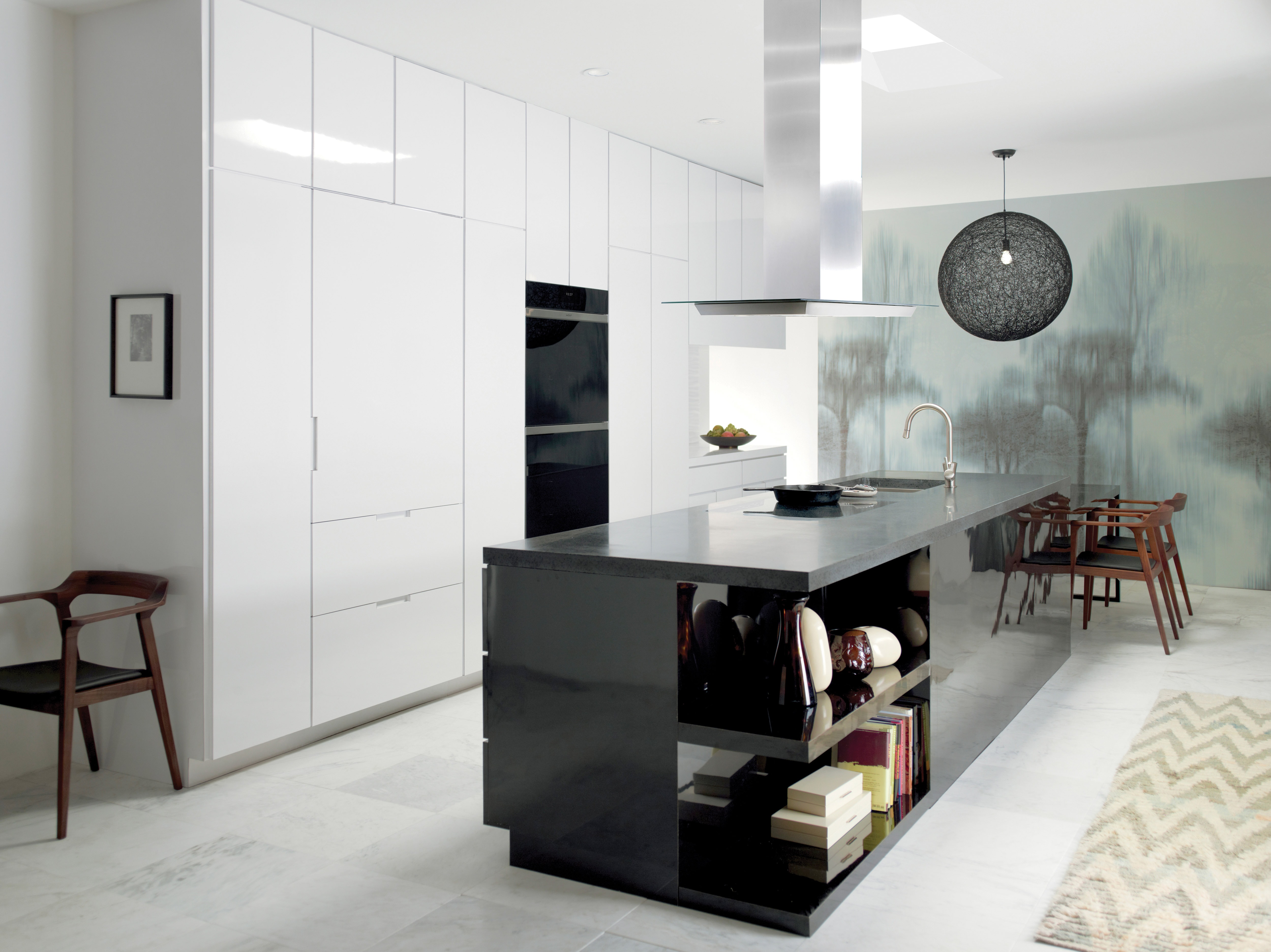 The Wolf 45" Cooktop Island Hood (VI45G) shown in contemporary kitchen featuring smooth and seamless white cabinetry