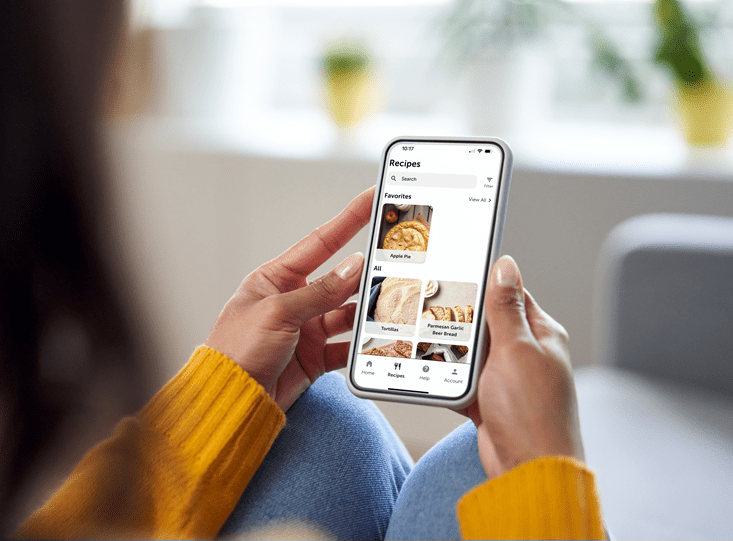 A woman viewing recipes on the Sub-Zero Group Owner's App to use with her luxury Sub-Zero, Wolf, and Cove appliances.