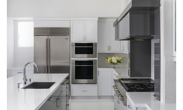 Clean, minimalist kitchen design featuring Sub-Zero Classic Series Refrigerator, Cove Dishwasher, Wolf M Series Oven, Sealed Burner Rangetop and Wolf Speed Oven