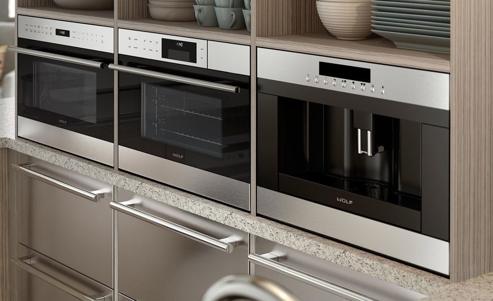 Wolf 24&quot; Coffee System Stainless Steel (EC24/S) shown with multiple Wolf appliances in clean horizontal cabinet display