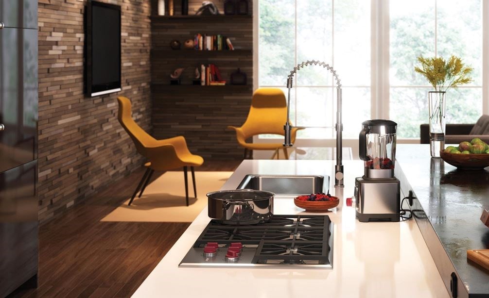 The Wolf 36&quot; Professional Gas Cooktop (CG365P/S) displayed in large center island surrounded by an array of rich earthy tones and textures