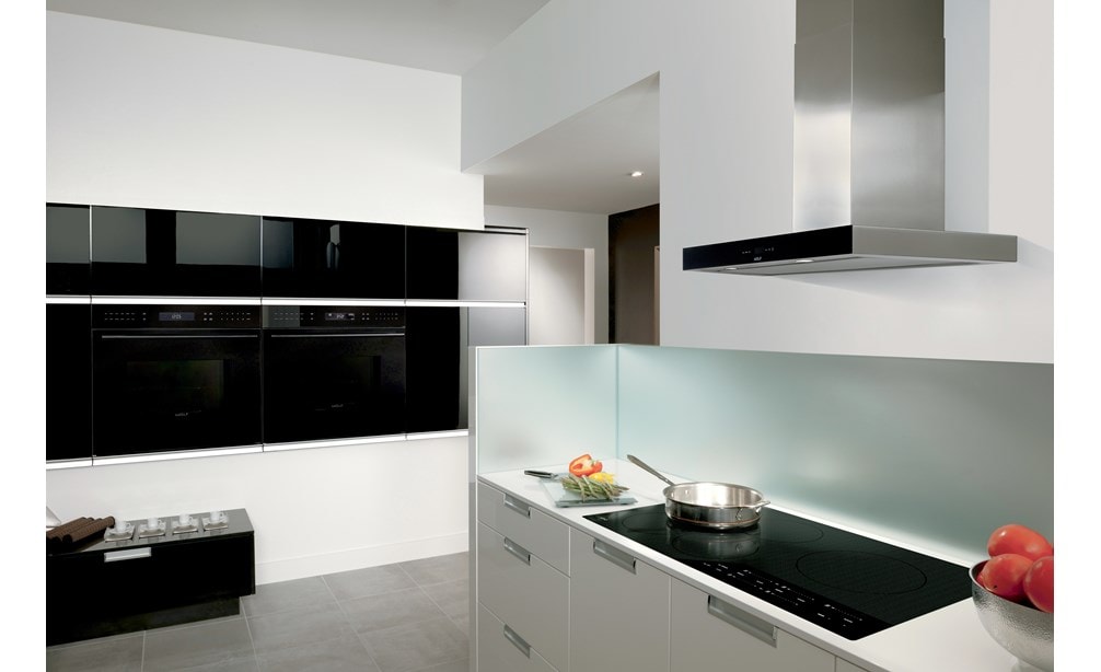 Wolf 36" Contemporary Induction Cooktop (CI365C/B) shown with 36" Cooktop Wall Hood Black (VW36B) shines in clean seamless kitchen design