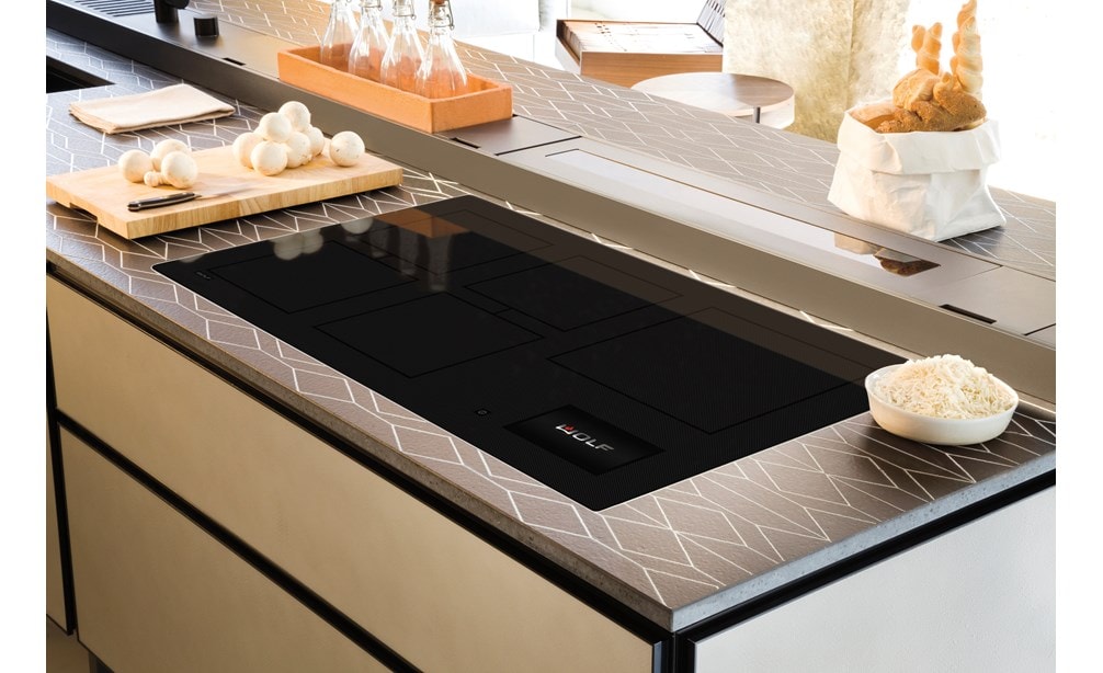Wolf 36 Contemporary Induction Cooktop (CI36560C/B) show set flush in custom kitchen countertops featuring continuous symetrical pattern.