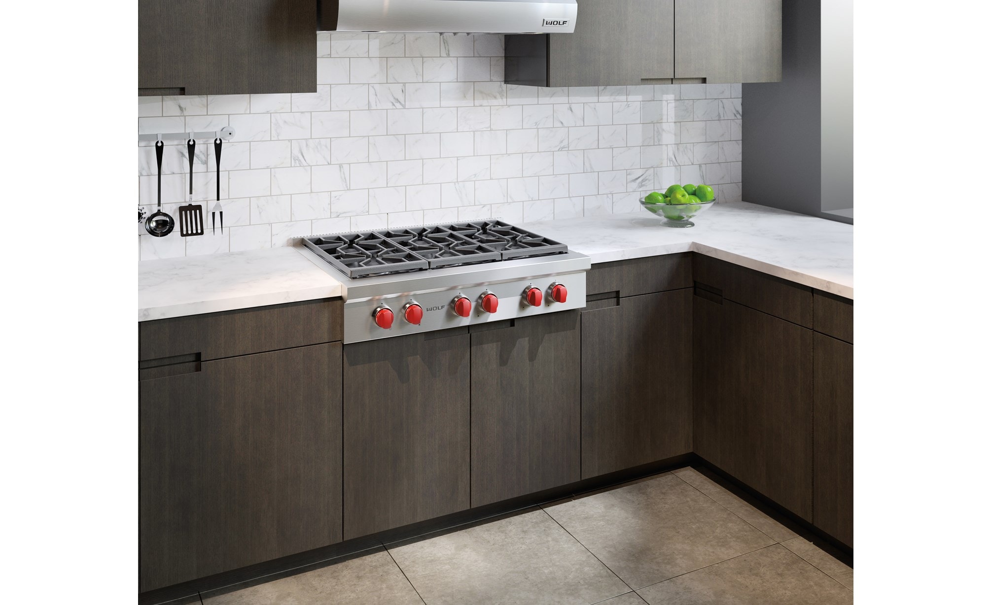 The Wolf 36" Sealed 6 Burner Rangetop (SRT366) shines in this classic kitchen setting next to flat panel cabinets and white brick wall