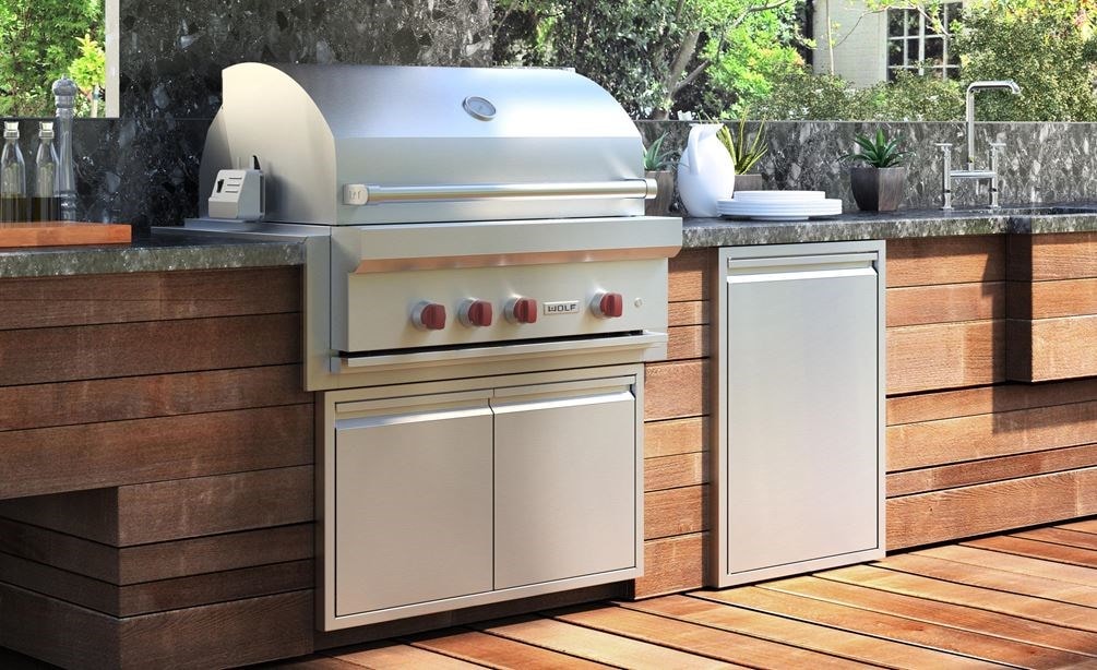 The Wolf 36" Outdoor Gas Grill (OG36) shown with Wolf Professional Grade Outdoor Ventilation Hood in this large outdoor kitchen. 