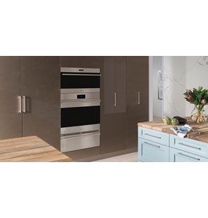 The Wolf 30" E series Transitional Drop-Down Door Microwave Oven (MDD30TE/S/TH) shown set flush in smooth floor to ceiling cabinetry