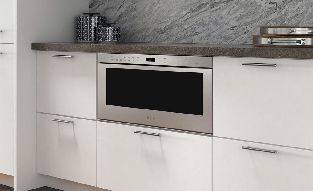 The Wolf 30" Professional Drawer Microwave Oven (MD30PE/S) shown adding ease and convenience set in classic white cabinetry 