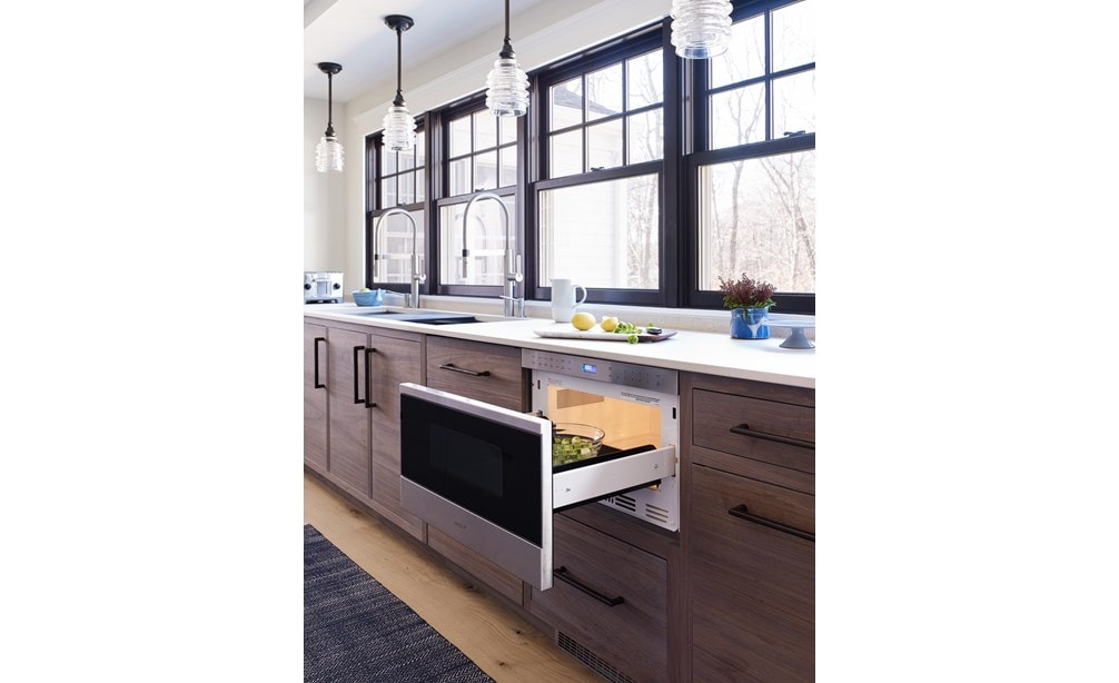 Wolf 24" Transitional Drawer Microwave (MD24TE/S) adds ease set flush in warm wood cabinets under white countertops in modern kitchen