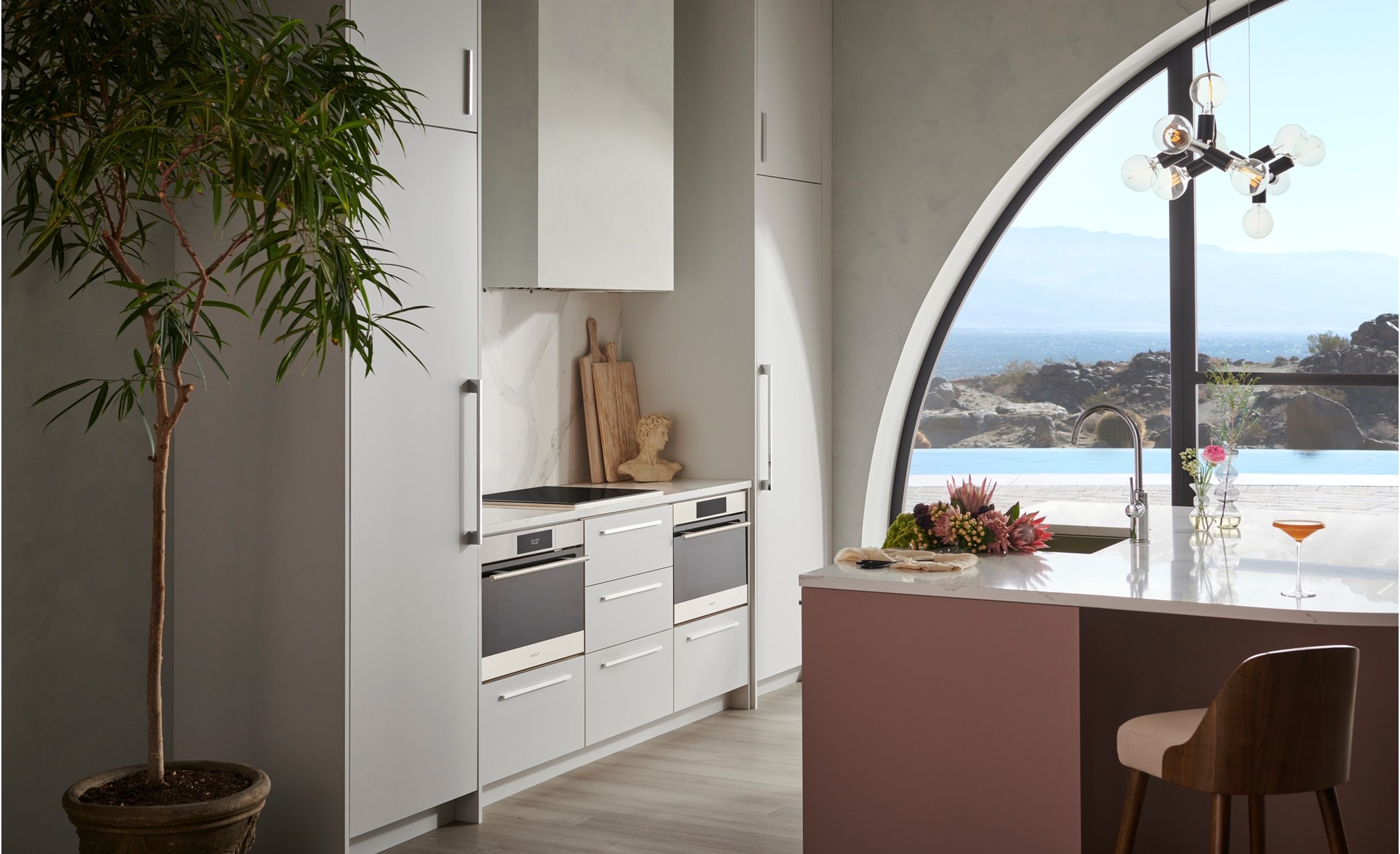 Wolf Convection Steam Oven displayed in minimalist European kitchen featuring white quartz countertops.