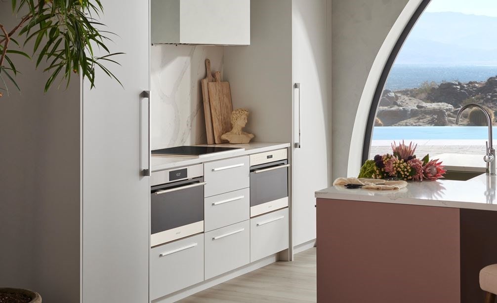 Wolf Convection Steam Oven displayed in minimalist European kitchen featuring white quartz countertops.