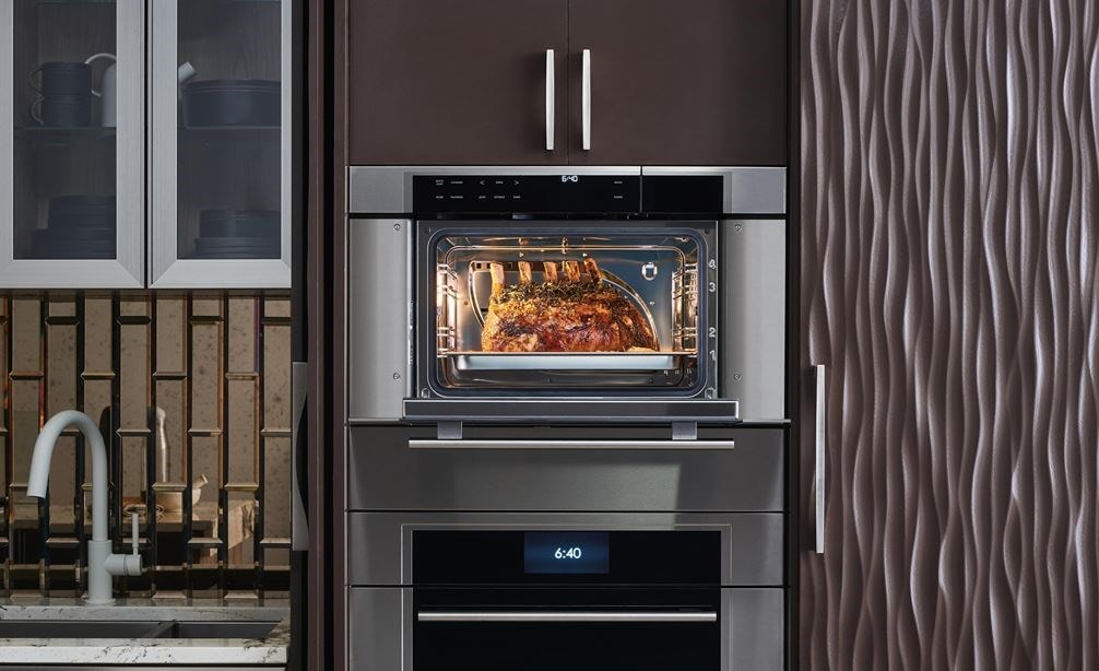 Wolf 30&quot; M Series Transitional Convection Steam Oven (CSO30TM/S/TH) displayed in an elegant arrangement of warm smooth kitchen cabinets