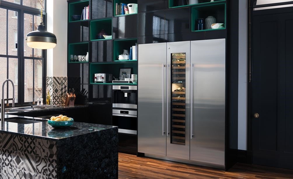 Wolf 24&quot; M Series Contemporary Stainless Steel Steam Oven (CSO2450CM/S) displayed in powerful black cabinetry alongside Volga blue granite countertops