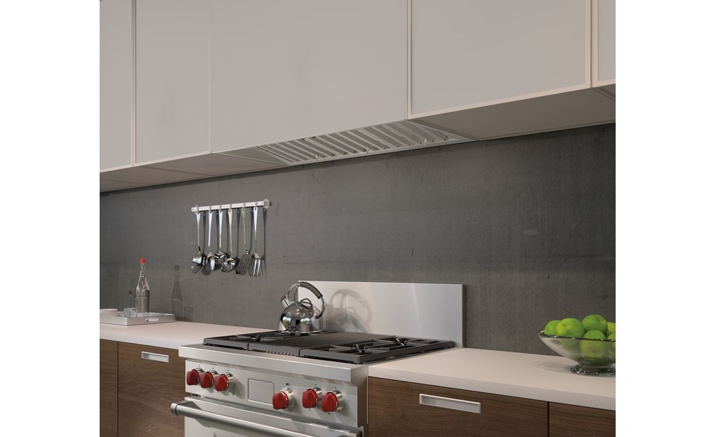 The Wolf 40" Pro Hood Liner 19" Depth (PL401912) shown blending seamlessly into smooth handleless cabinets in minimal kitchen design