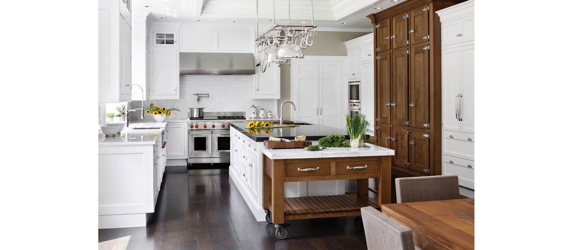 Wolf 54" Pro Wall Hood 27" Depth (PW542718) shown with 48" Gas Range 6 Burners and Infrared Griddle (GR486G) in classic white kitchen