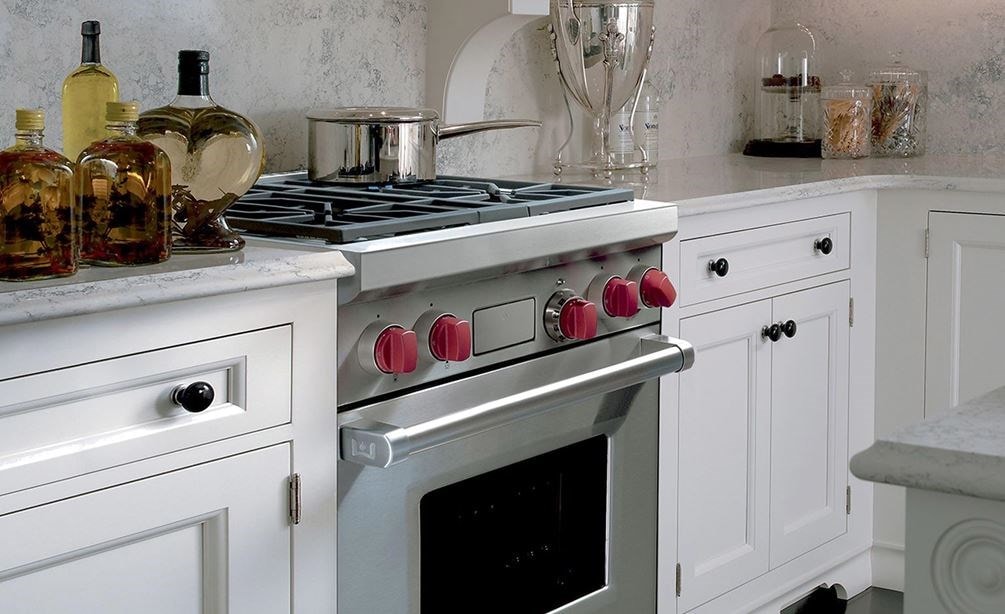 The Wolf 30&quot; Dual Fuel Range 4 Burner (DF304) Cooktop shown beautifully integrated into a classic kitchen design.
