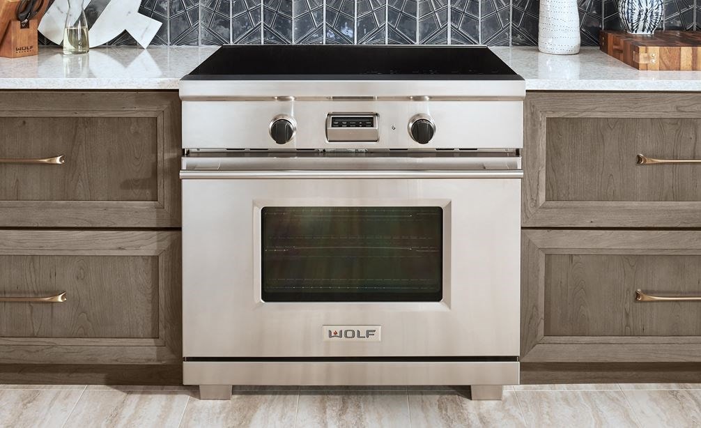 The Wolf 36&quot; Transitional Induction Range (IR365TE/S/TH) featured with Wolf 36&quot; Cooktop Wall Hood - Glass (VW36G)