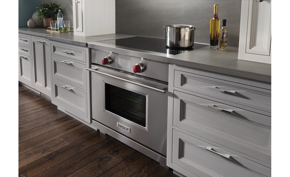 The Wolf 36" Transitional Induction Range (IR365TE/S/TH) displayed in a sleek flush inset blending seamlessly into countertops