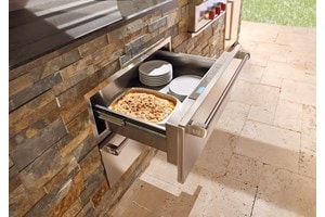 Wolf 30" Outdoor Warming Drawer (WWD30O) shown in a gourmet outdoor cooking area featuring best in quality Wolf cooking appliances