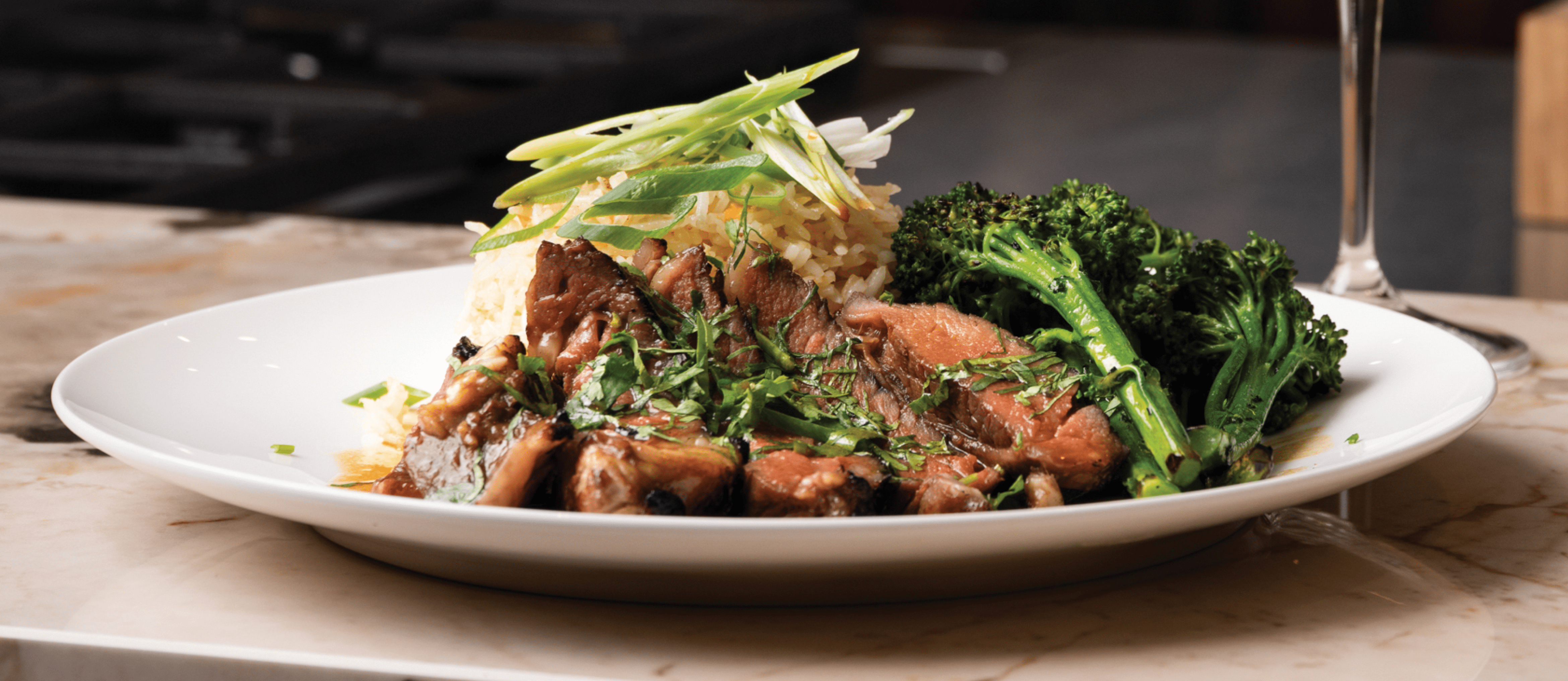 Glazed Teriyaki infused Rib of Beef with Steamed Coconut Fried Rice and Charred Sesame Broccoli