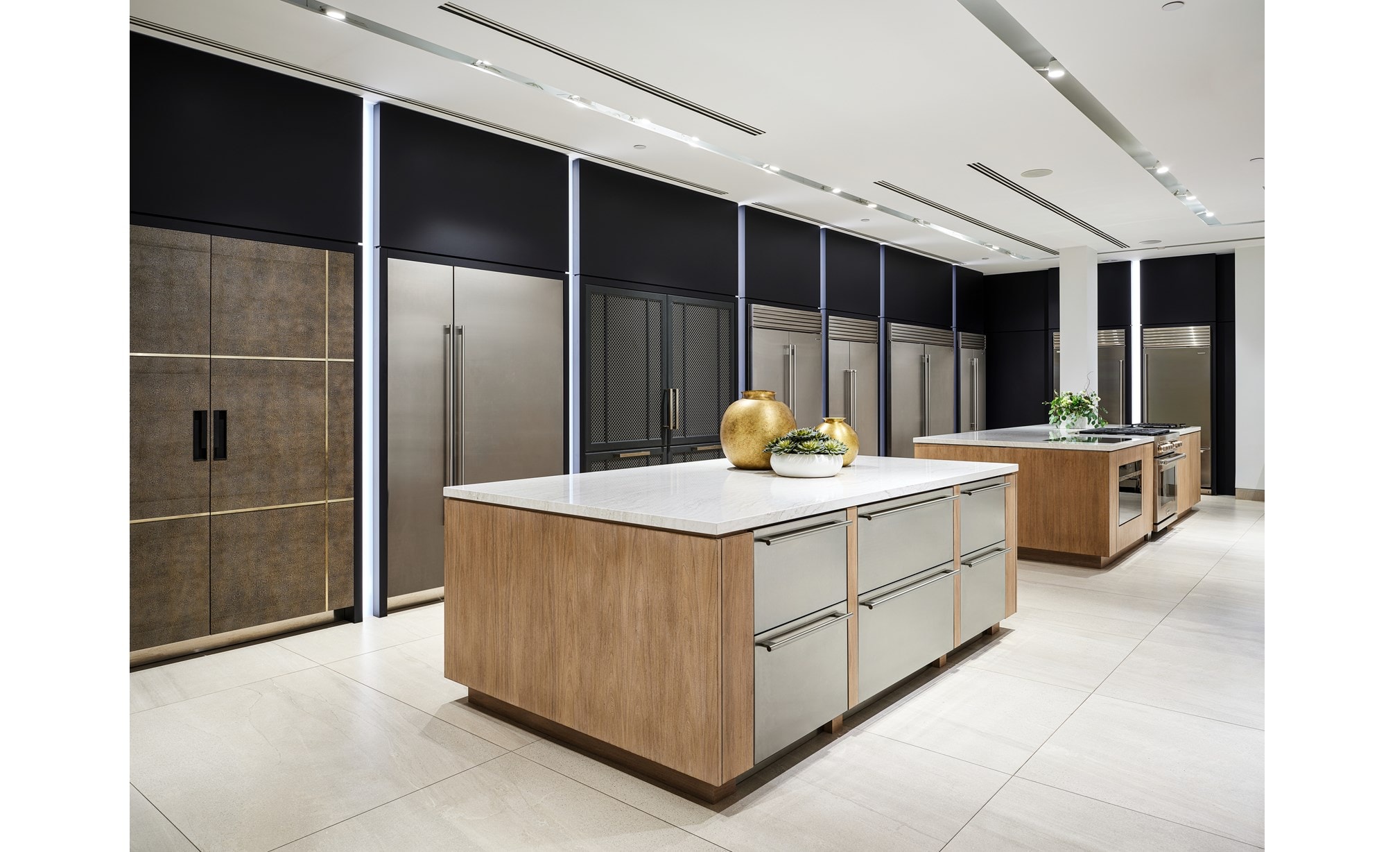 A wall of built-in Sub-Zero refrigerators in different shapes, configurations, and sizes. 
