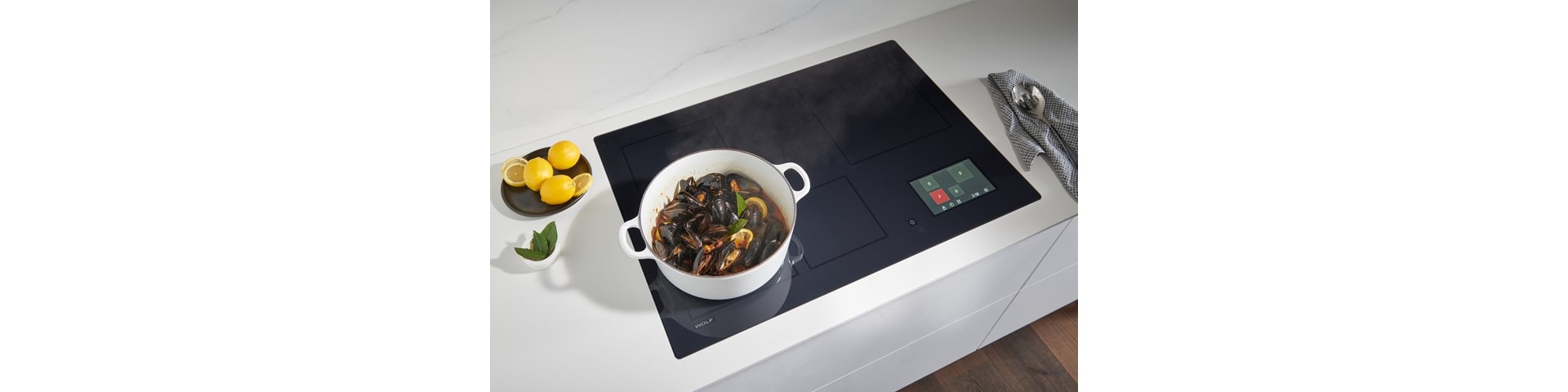 Wolf 36-inch Induction Cooktop (CI36560T/S) shown here delivering astonishing speed, control, and responsiveness for perfect Wok cooking.