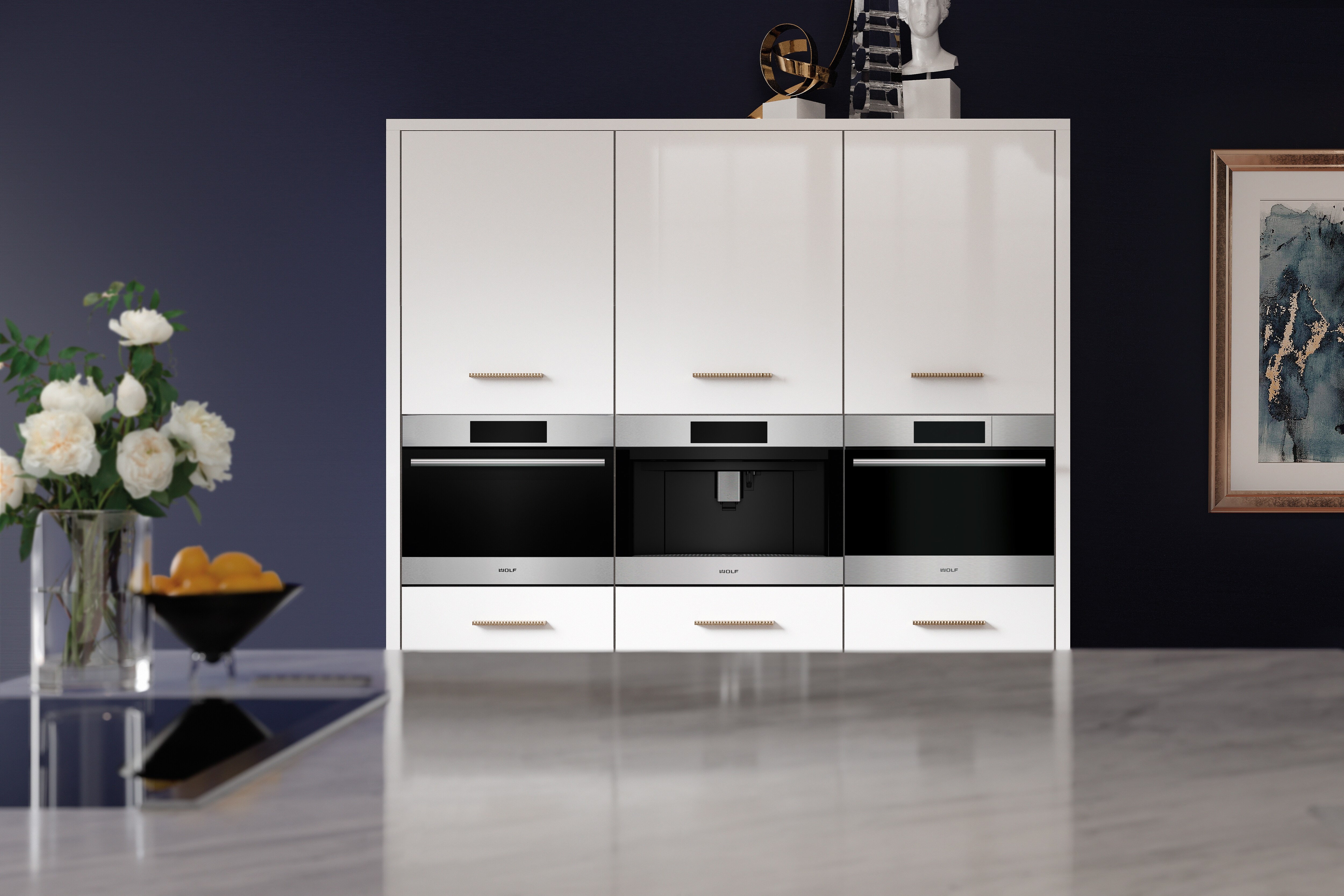 A Wolf built-in speed oven, coffee system, and a convection steam oven side-by-side in a white cabinet