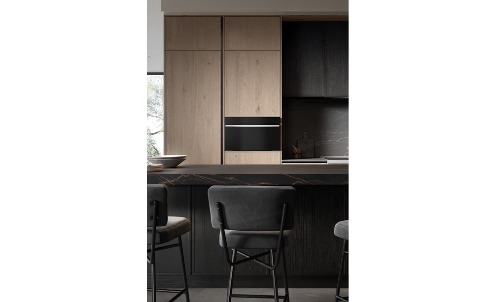 A close-up image of the Wolf 30" M Series Contemporary Speed Oven - SPO3050CM/B/T in a modern black kitchen