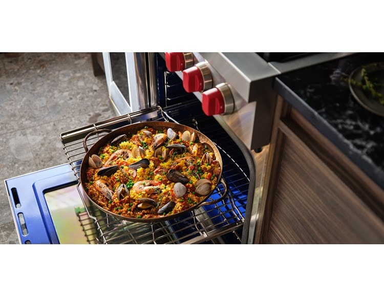 Wolf Dual Fuel Range shown roasting heritage tomatoes using reliable heat from Wolf's Dual VertiFlow convection system